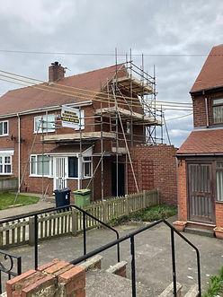 Scaffolding structure set up on the front exterior of a two-story residential house