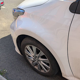 Close-up of the sleek side panel of a white car