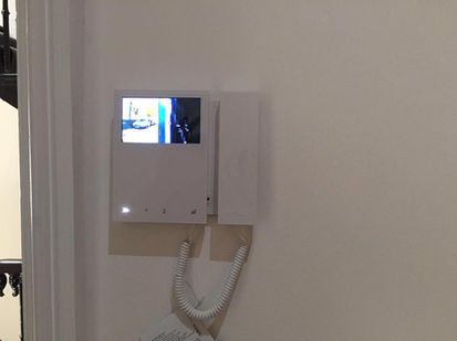 A smart door lock with a camera screen and telephone receiver