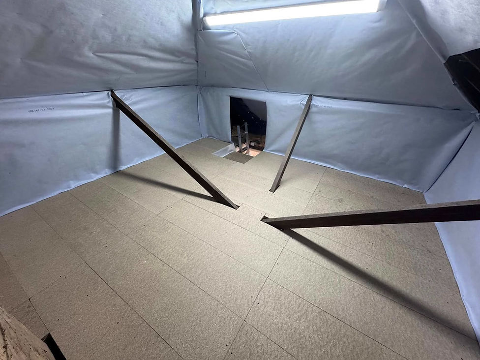 Spacious attic interior fully lined with bright white protective insulation sheeting