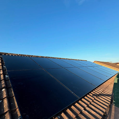 Rooftop solar panels under a clear blue sky