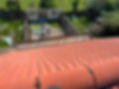 Aerial view of a red-tiled roof with scaffolding