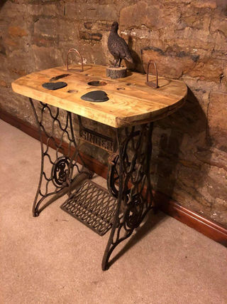 A sewing machine table with a small bird perched on top