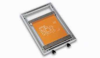 Solder paste frame assembly fixture holding a small copper colored board