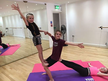3 young students doing acrobatic sequence