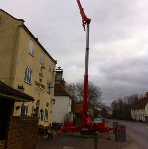 A cherry picker outside a house