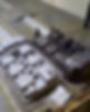 Two automotive valve covers, one is cleaned by sand blasting