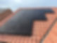 solar panels installed on a sloped red-tiled roof
