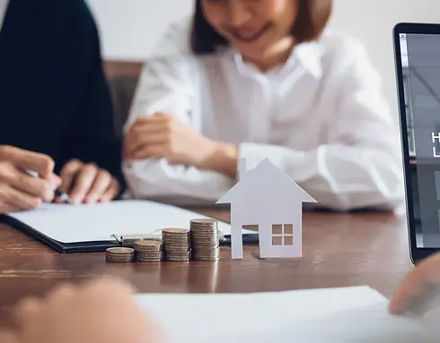 Two people in a meeting, focusing on documents