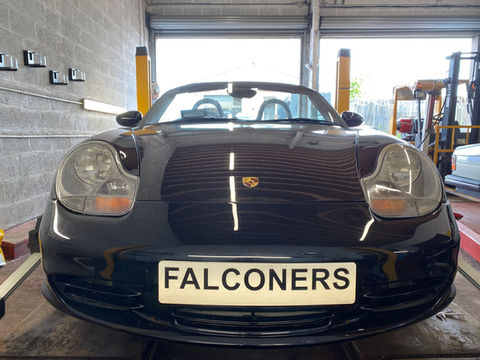 A black Porsche car with the word "Falconers" on it