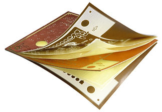 Hands peeling back individual production substrate sheets of a multilayered circuit board