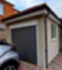 A modern garage with a grey roller door