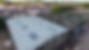 Aerial view of an industrial site with two large warehouse roofs