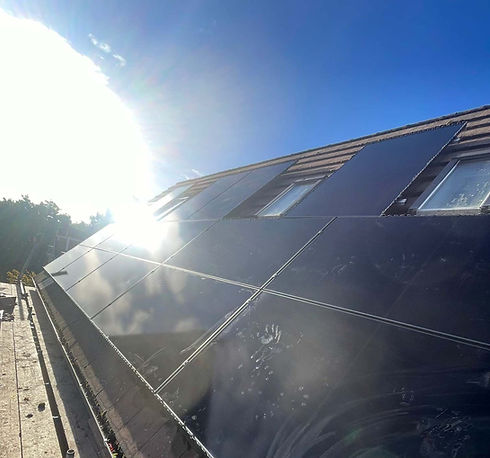 Sunlight reflecting off a freshly repaired residential rooftop solar array setup