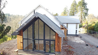 A completed bright contemporary single-story home extension with large glass windows