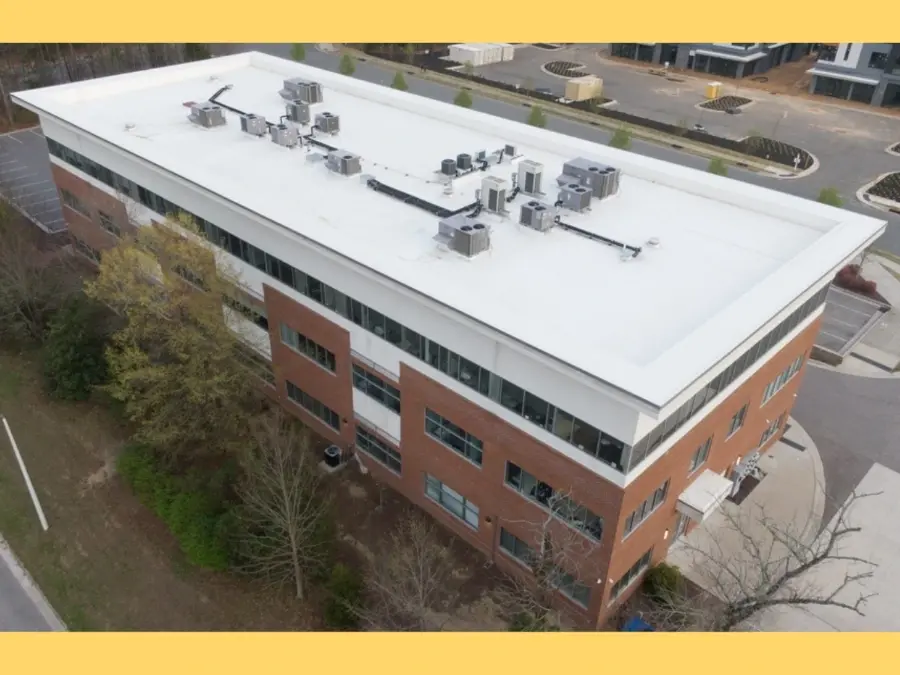 Aerial view of a commercial flat roof with HVAC units, illustrating roof inspection cost factors in Ontario.