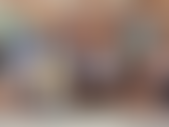 12 young children and their art instructor in front of the wall at Riverfront Renaissance Center for the Arts showcasing their work from their session proudly with their instructor.