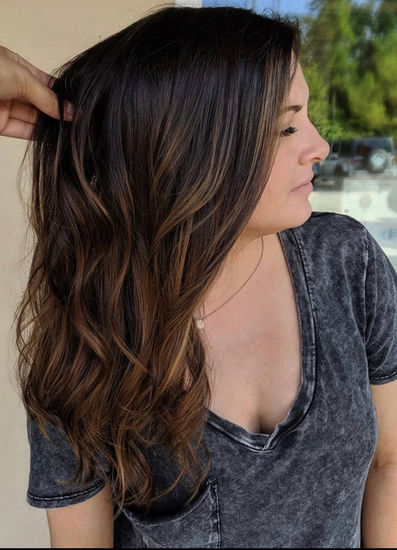 Long brunette with highlights and soft waves at Hello Beautiful Signature Salon in Sugar Land