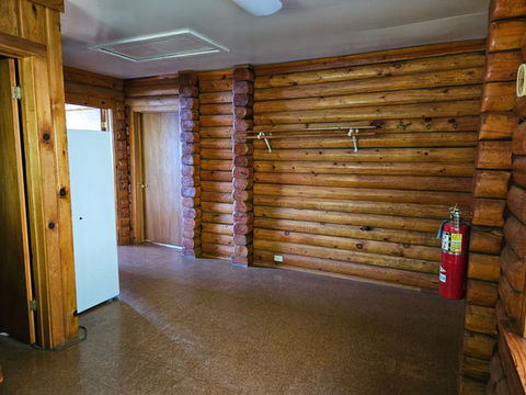 2nd floor - Log interior, back entry area looking at hall door, open kitchen entry, refrigerator & pantry area, back entry to the right, Waterfront Homestead for sale, Kupreanof Island Alaska