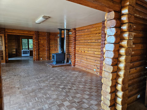 Wood log interior, wood stove living area, Toyo stove in Den area, Waterfront Homestead for sale, Kupreanof Island Alaska