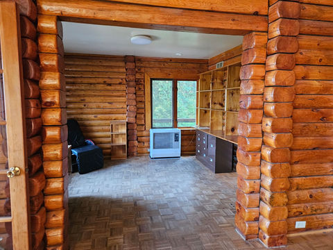 Log interior, den / office area, Toyo stove, east and south facing windows, Waterfront Homestead for sale, Kupreanof Island Alaska