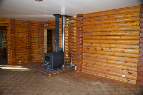 2nd floor - Interior log walls with wood stove, den & hall entry, Waterfront Homestead for sale, Kupreanof Island Alaska
