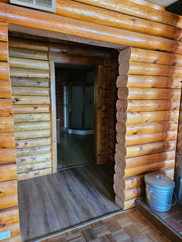 Looking from living area through hallway into bathroom, facing west inside home, log interior, Waterfront Homestead for sale, Kupreanof Island Alaska
