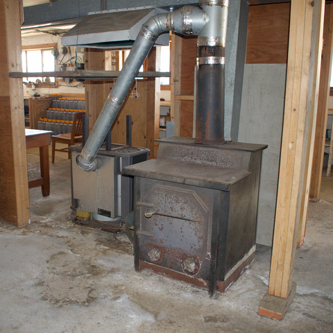 1st floor, basement oil stove on the left and wood stove on the right. Oil stove runs 24/7 keeping the whole house warm, Waterfront Homestead for sale, Kupreanof Island Alaska