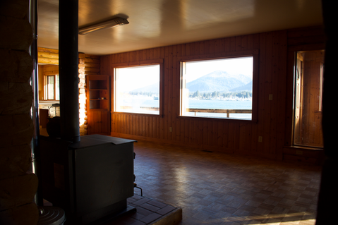 2nd floor - Living area, large east facing windows overlooking water, deck entry, wood log interior den & living area, Waterfront Homestead for sale, Kupreanof Island Alaska
