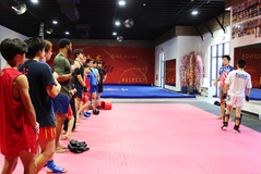 Self defense class lined up listening to martial arts instructor