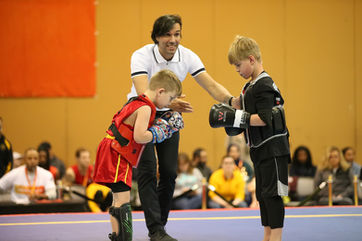Kids showing respect to each other during MMA, Sanda and Kickboxing tournament