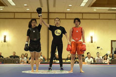 Female fighters with female judge at MMA, Self Defense tournament