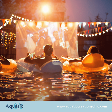 People relax on pool floats at an outdoor movie party under string lights; Aquatic Creations and website displayed.