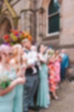 A family blowing bubbles outside the wedding ceromony of the newly wed couple photographed by Cally Jordan