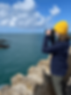 Amelia the founder of Deep Blue Collective using her binoculars to look for signs of cetaceans on the Welsh coast