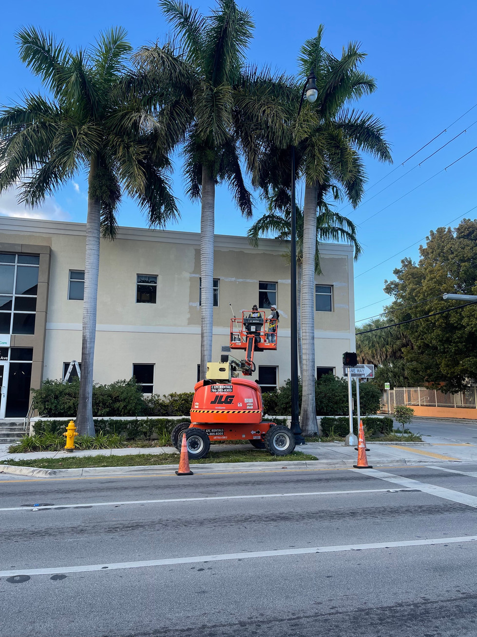 Professional pressure cleaning before exterior building painting.