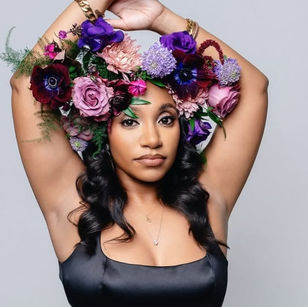 A woman stands poised on a sunlit train platform, ready for her journey with a stylish carry-on suitcase