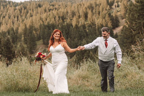 Man and woman holding hands on their wedding day