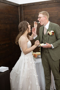 Bride and groom feeding each other cake 