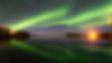 Northern Lights illuminating the sky over a canoe at Sandy Bay, Saskatchewan.