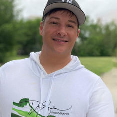 Dre Erwin poses stylishly in one of his Dre Erwin signature sweaters, exuding warmth and inspiration. Rural healthcare