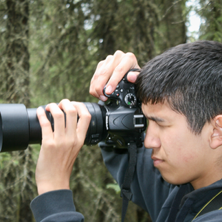 Louis Iron youth in PInehouse learning therapeutic photogrpahy for depression after his dad died from suicide