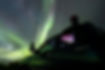 Boy gazing at the Aurora Borealis from the window of a blue truck in Pinehouse Lake, illustrating the concept of the Law of Attraction - 'You become what you think of the most