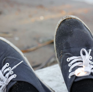 First-person view of sandy blue canvas shoes. Captured during a Therapeutic Photography mentorship session with Dre Erwin.