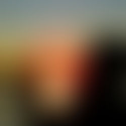 A silhouette photograph of a person making a heart shape with their hands around a glowing sun at sunset over a frozen body of water (image_6.jpg). This image was captured during a Therapeutic Photography session founded by Dre Erwin, an initiative focusing on youth mentorship and emotional expression through art in remote communities. View the full project at dreerwinphoto.com.