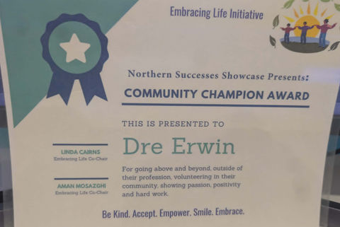 Community Champion Award certificate presented to Dre Erwin for going above and beyond in volunteering for cultural activities and community betterment.