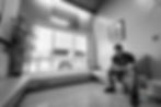 A black-and-white wide-angle photograph of Dre Erwin, a Registered Nurse and mental health