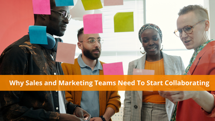 A group of colleagues from both the sales and marketing teams stands in front of a wall with sticky notes, discussing revenue strategy.