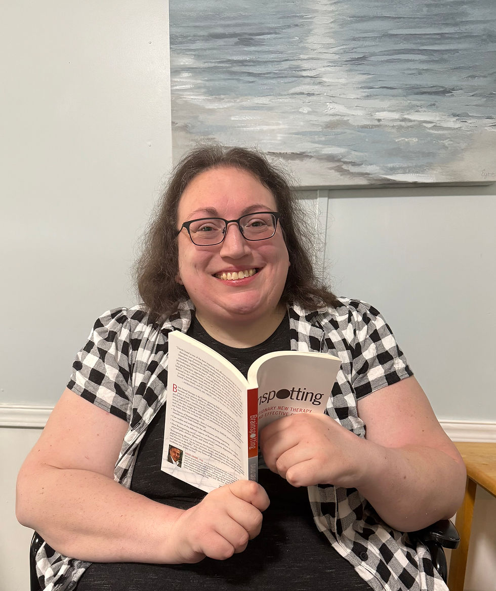 Image of Healing Current Trauma Therapy Practice Founder, Clinician and EMDR Certified Therapist reading a Brainspotting book
