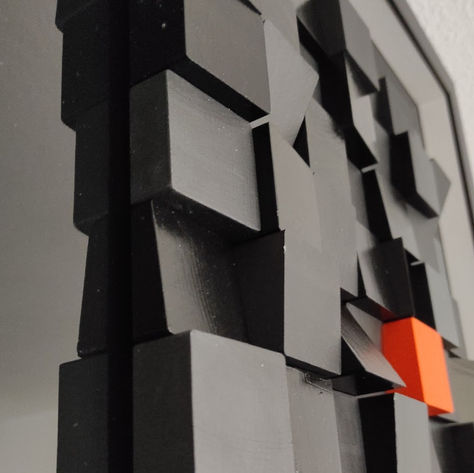 Détail des cubes noirs coupés en biais et du cube orange
